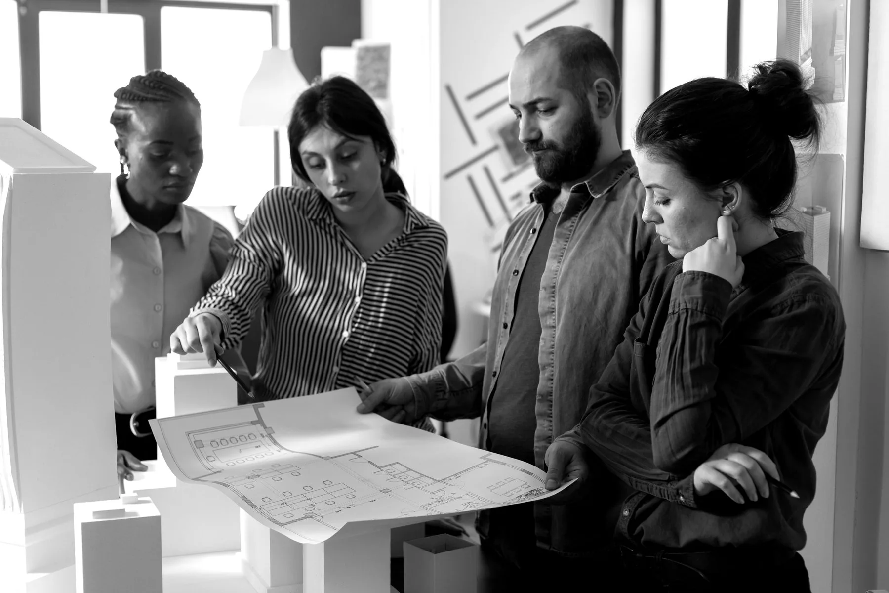 Architects working together on architectural drawings